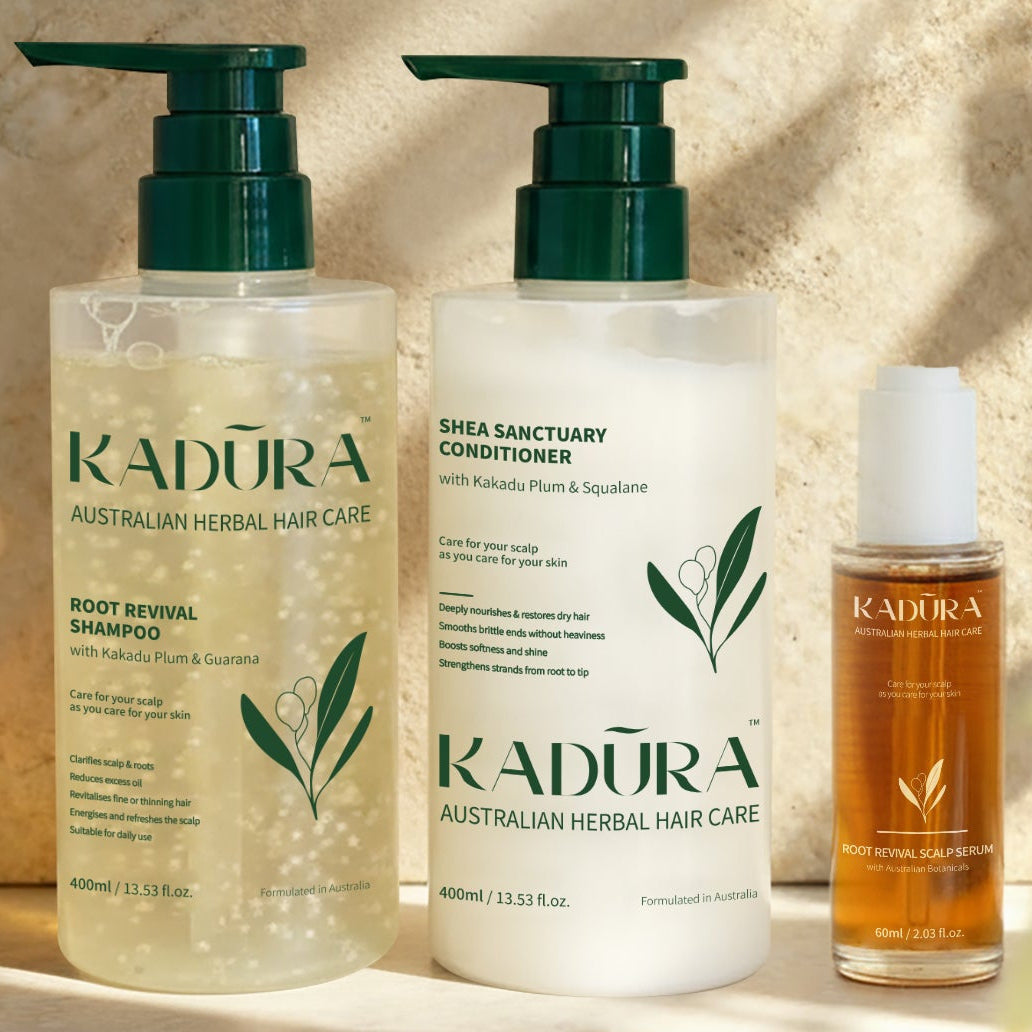 Kadura Australian Herbal Hair Care products including shampoo, conditioner, and oil on a neutral background.