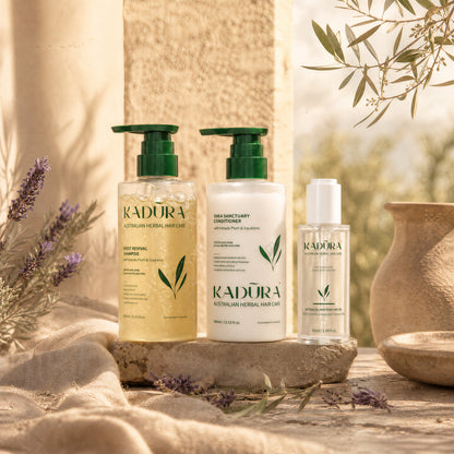 Kadūra CurlDefine Trio for curly hair with shampoo, conditioner and botanical hair perfume oil in a sunlit botanical setting
