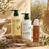 Kadūra RootRevive Scalp Care Trio for hair fall with shampoo, conditioner and scalp serum in a sunlit botanical setting